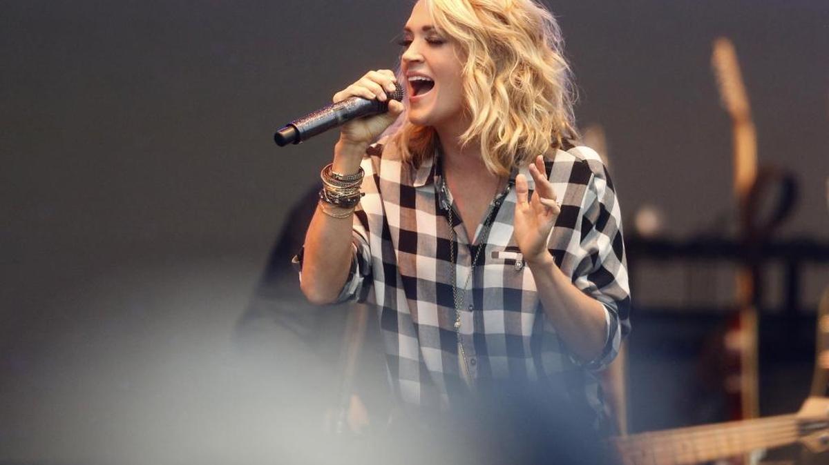 Carrie Underwood performs during the Belk Bowl FanFest outside of Charlotte’s Bank of America Stadium in Charlotte on Dec. 30, 2015.