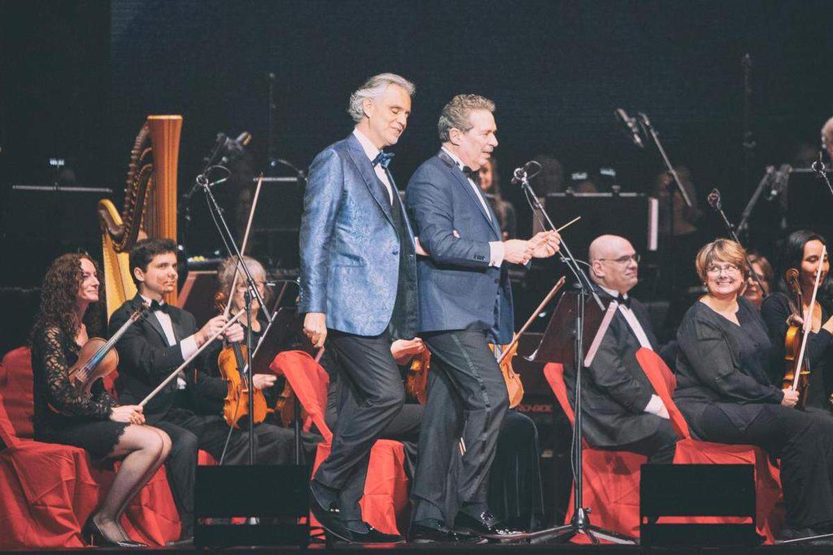 Andrea Bocelli is led onto the stage by his music director, Eugene Kohn, at Spectrum Center in Charlotte on Sunday night.
