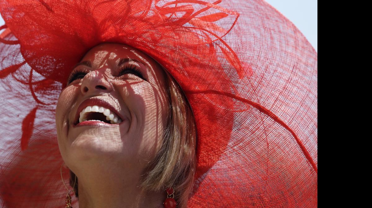 
Sara Ward looks up before the 141st running of the Kentucky Oaks horse race at Churchill Downs Friday, May 1, 2015, in Louisville, Ky.

