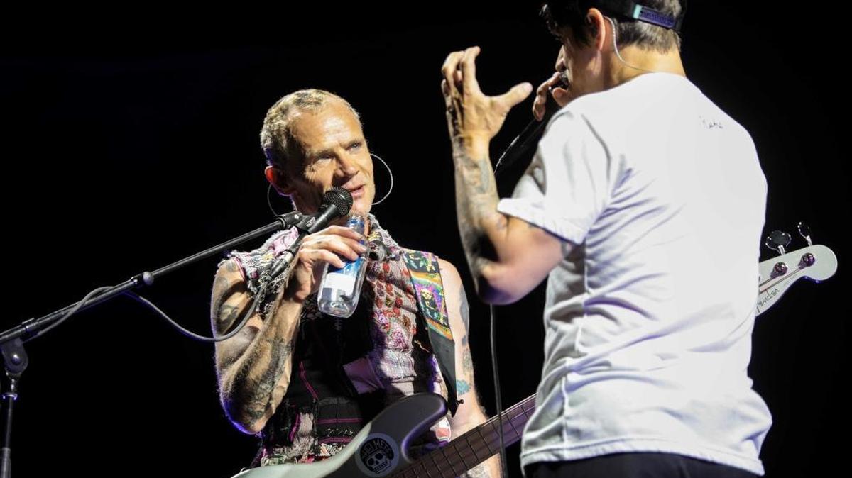 Bassist Flea and lead singer Anthony Kiedis banter during the Red Hot Chili Peppers concert at Spectrum Center on Monday night.