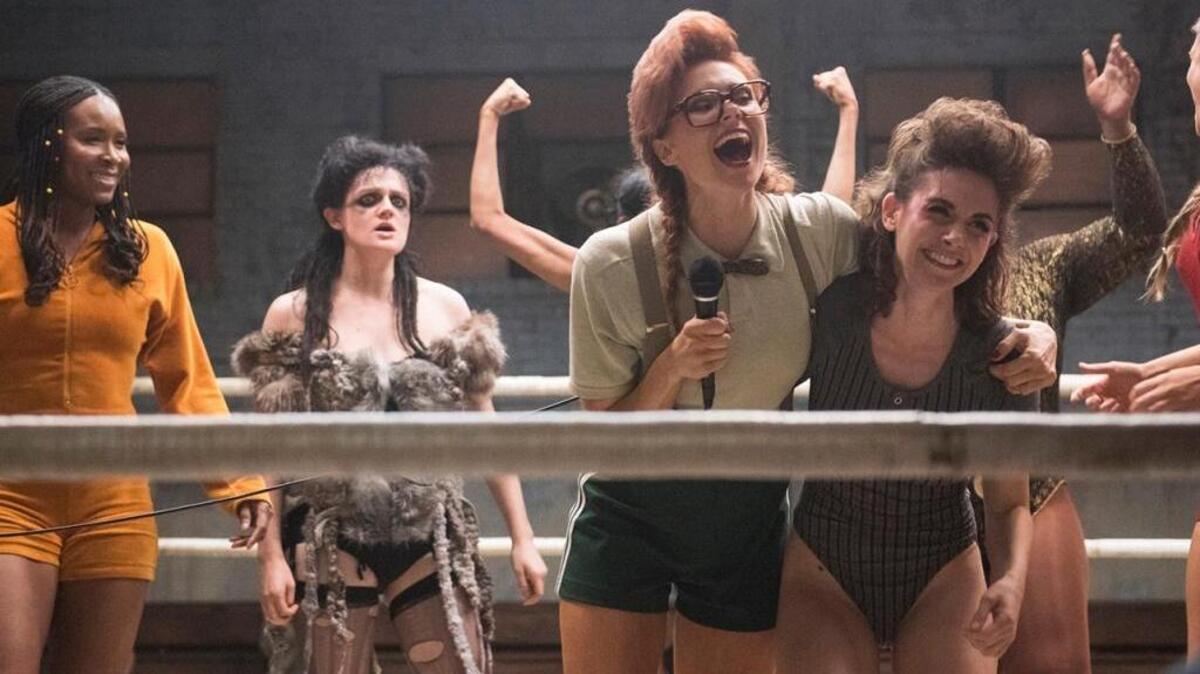 Kate Nash holds onto the microphone in character as Britannica on the Netflix series “GLOW.”