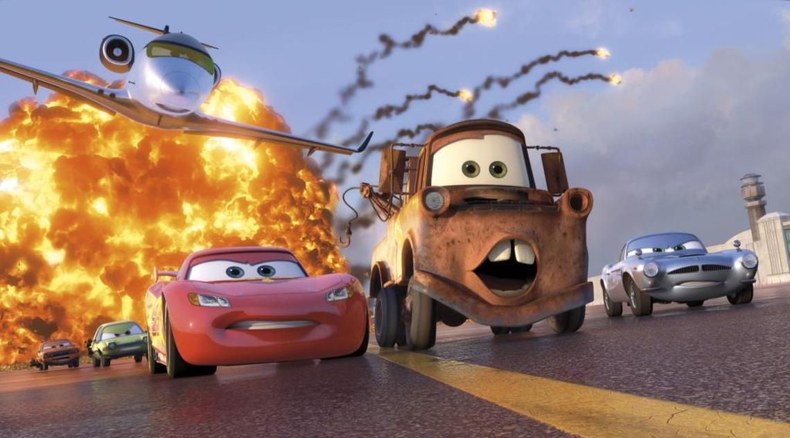 Animated characters Lightning McQueen (voiced by Owen Wilson), foreground left, Mater (voiced by Larry The Cable Guy), center, and Finn McMissile (voiced by Michael Caine), right, are shown in a scene from “Cars 2.”