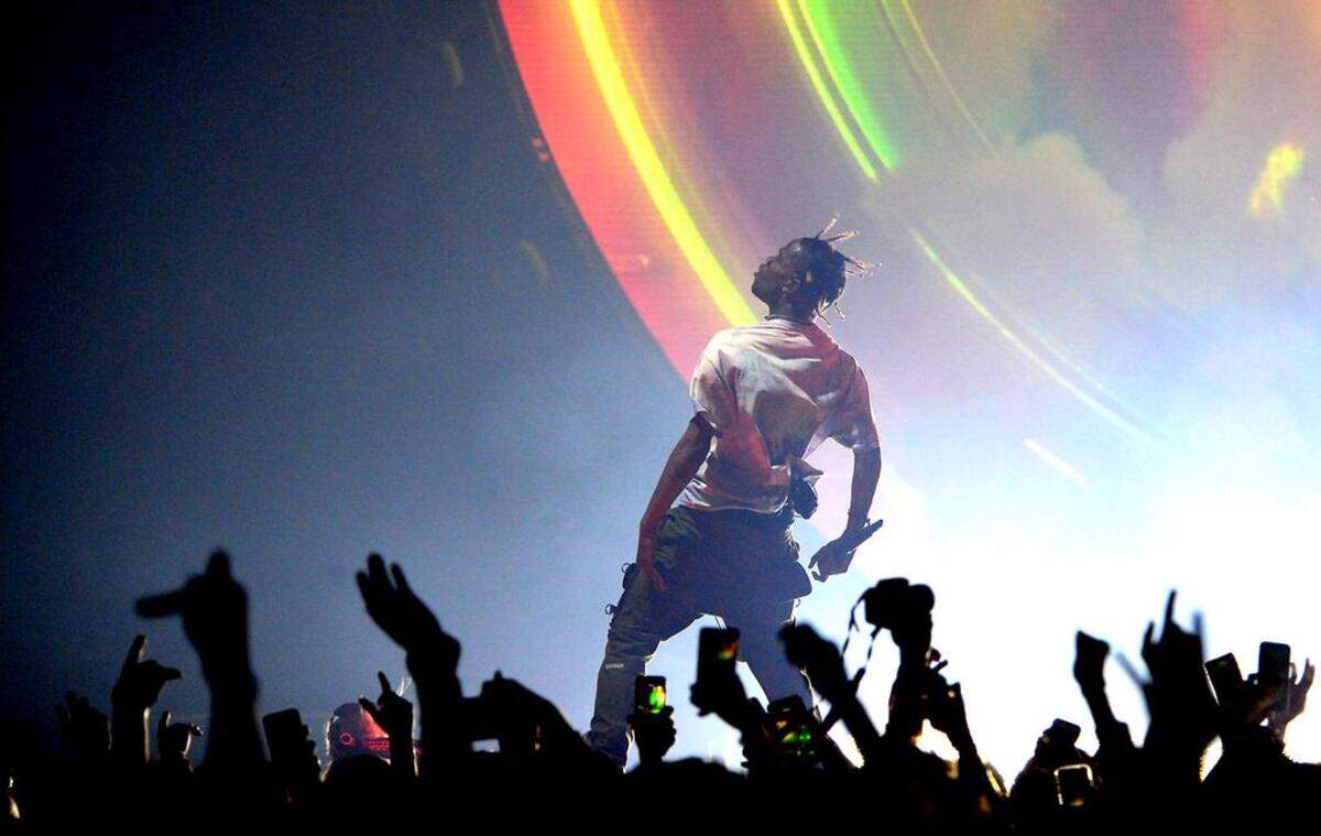 Travis Scott performs as the crowd goes wild.