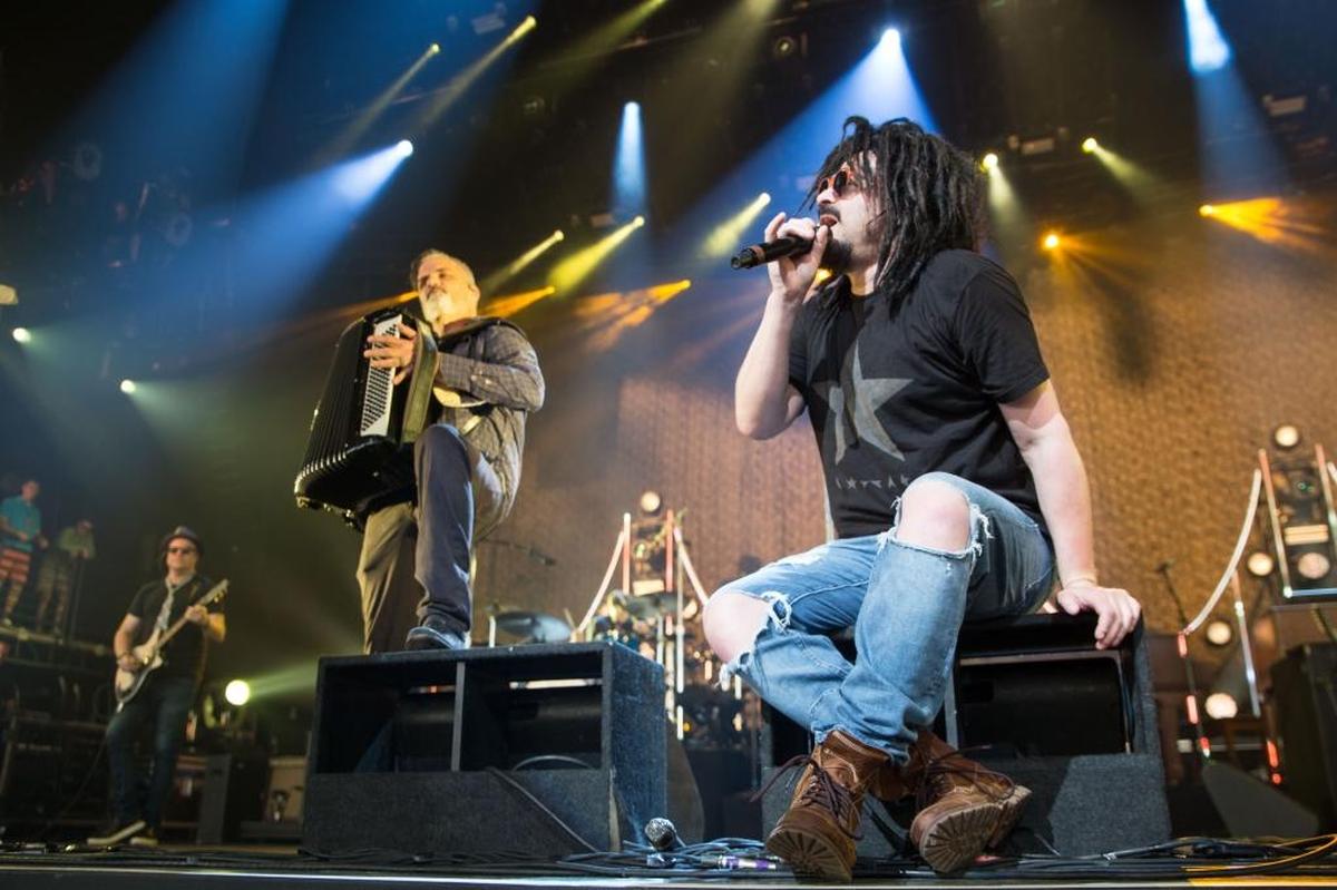 Adam Duritz of Counting Crows (seated) performs Sunday night in Charlotte at the PNC Music Pavilion.