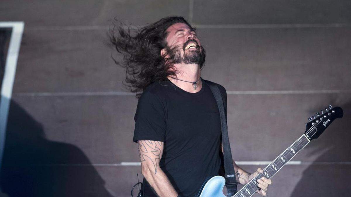 FILE- In this July 10, 2017, file photo, the Foo Fighters’ Dave Grohl performs in the ancient theatre of Herodes Atticus under the Acropolis in Athens. The Foo Fighters will headline a pre-Super Bowl concert in Atlanta. News outlets report the 12-time Grammy award-winning group will headline the DirecTV Super Saturday Night concert Feb. 2, 2018, at a temporary venue to be constructed on site at Atlantic Station. (AP Photo/Petros Giannakouris, File)