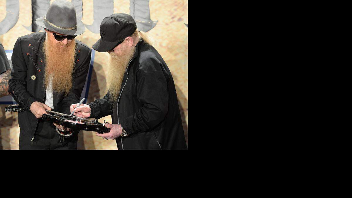 
Billy Gibbons,left, and Dusty Hill of ZZ Top signed a guitar at the Coca Cola 600 press conference, Tuesday, April 7, 2015. The guitar will be auctioned off, with proceeds going to Speedway Children's Charities. ZZ Top, who were inducted into the Rock and Roll Hall of Fame by Keith Richards of the Rolling Stones, will bring their iconic tunes, trademark beards and dark sunglasses to Charlotte Motor Speedway for what promises to be an energetic pre-race concert to get fans revved up before the green flag falls on the Coca-Cola 600, Sunday, May 24.
