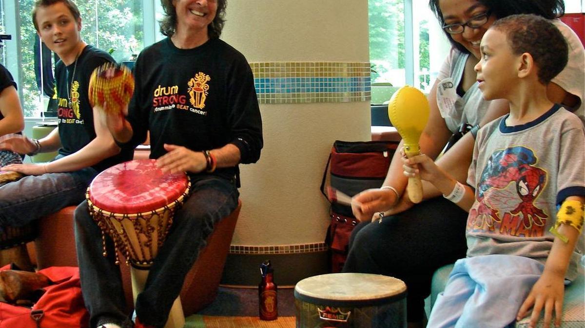 Scott Swimmer leads a hospital drum circle for sick children.
