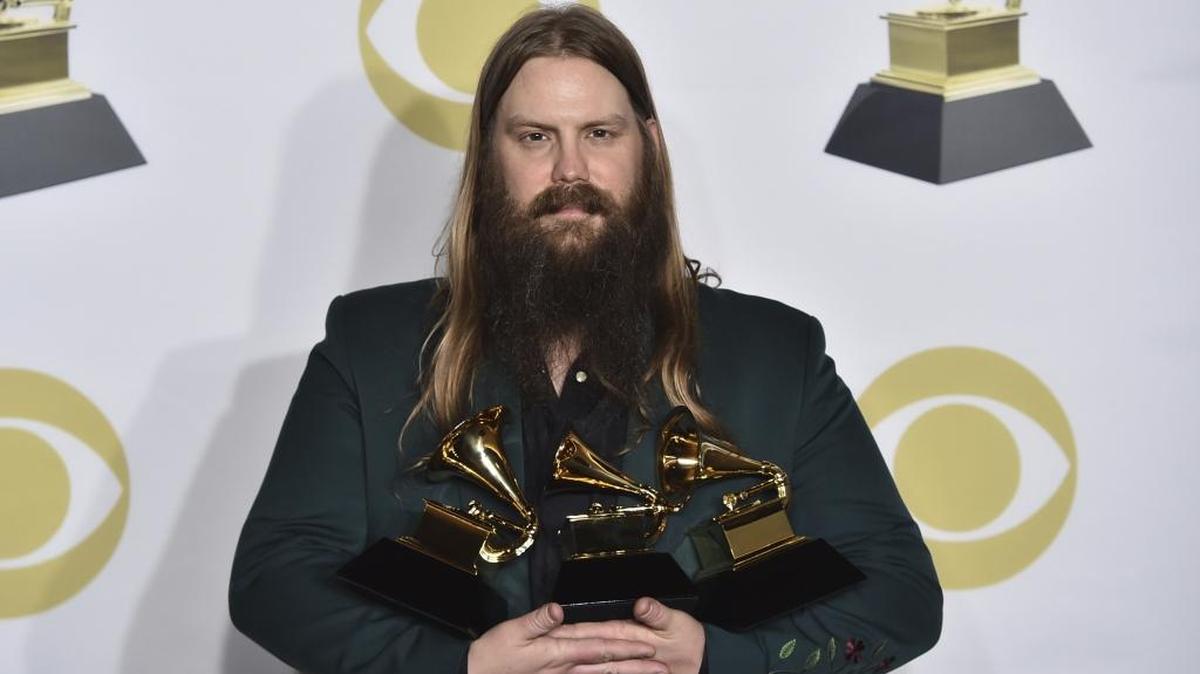 Chris Stapleton poses in the press room with his three trophies at the 60th annual Grammy Awards at Madison Square Garden in New York on Sunday night.