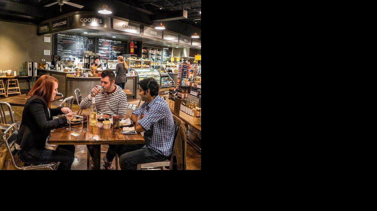 
From left, Kaitlin Krogh, Josh Krogh and Joel D'Souza enjoy their dinner with wine and beer at Earl’s Grocery.


