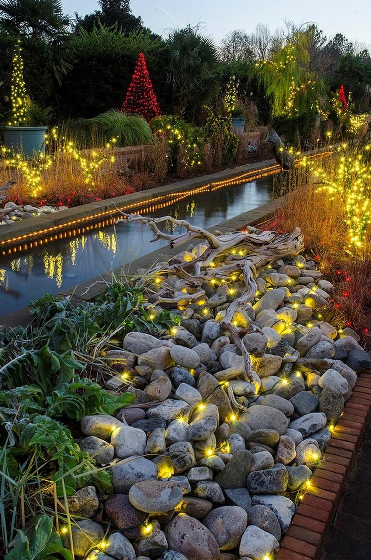 Daniel Stowe Botanical Garden opens its annual Holiday at the Garden this weekend where walkways – like this one beside the canal – are decorated with lights and ornaments for the season.