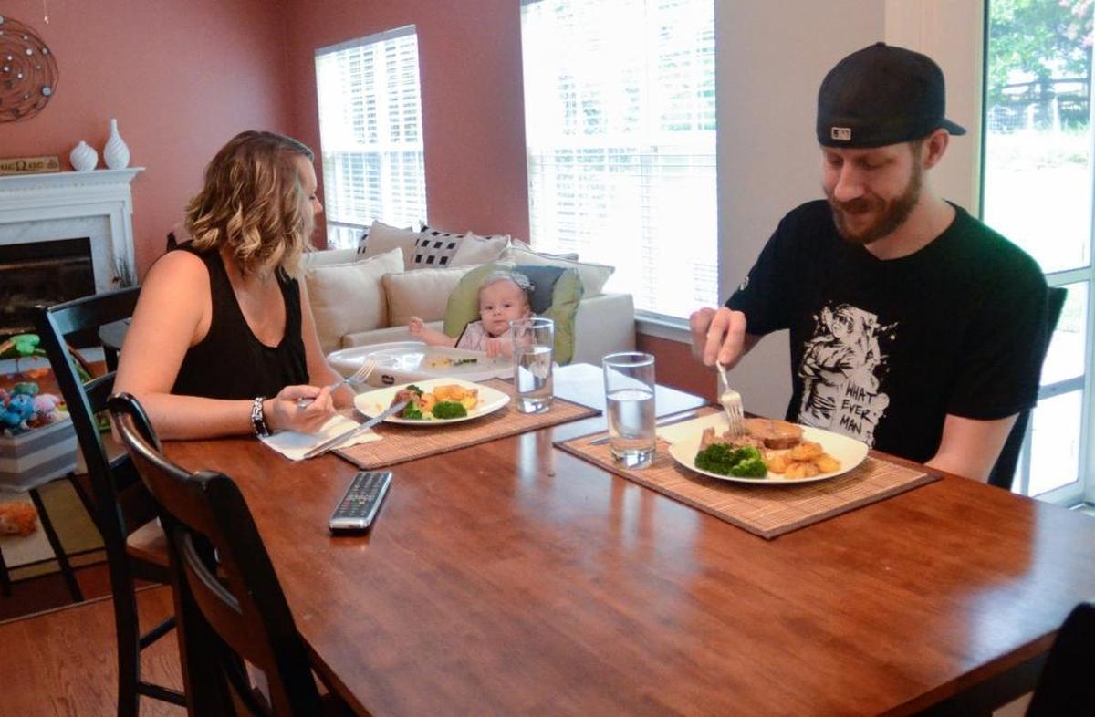 Tim MacRae has dinner with his wife, Suzana, and daughter, Mia. The suburban Charlotte dad helped convince his wife that gaming on the Twitch platform was paying off with a remodeled kitchen they dubbed “the Twitchen.”