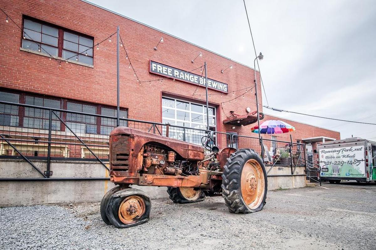 An old tractor sits in front of Free Range Brewing, which recently opened at 2320 N. Davidson St. Breweries in close-in neighborhoods light NoDa and Villa Heights may be paying much higher taxes next year.