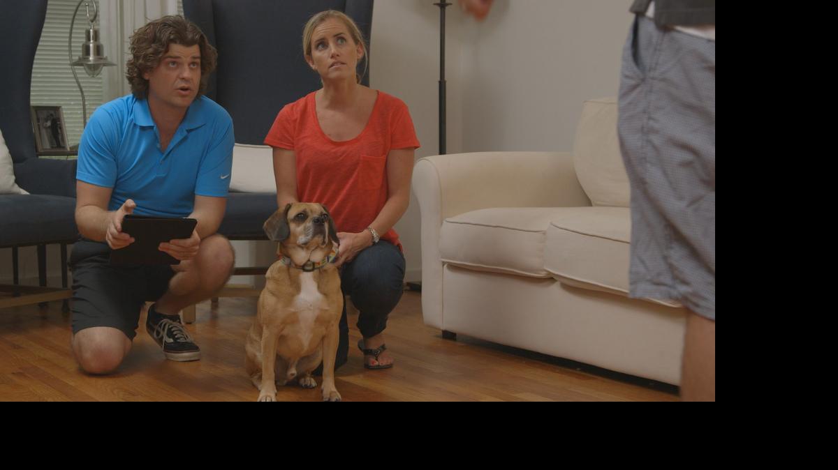 
In Chapel Hill, Dr. Brian Hare (left), Leyf Starling and Brutus the dog watch as Jim Starling gives hand commands while playing Dognition. 
