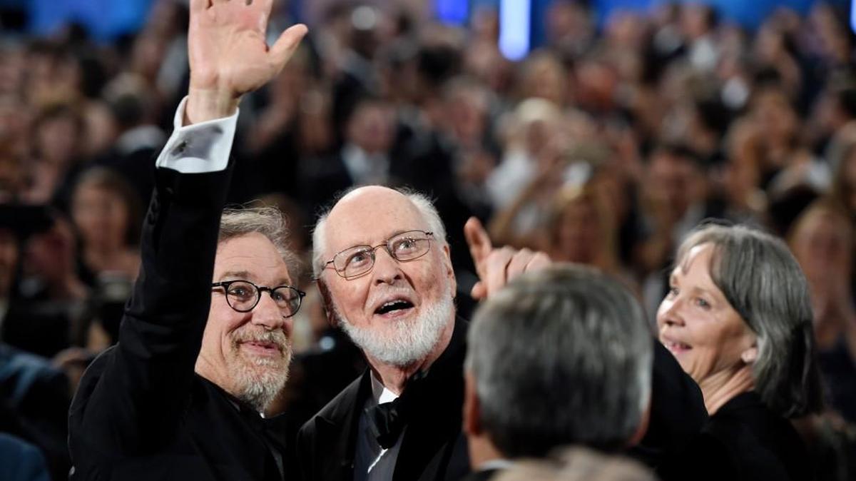 Filmmaker Steven Spielberg, left, and composer John Williams wave to the audience during the 2016 AFI Life Achievement Award Gala Tribute to Williams at the Dolby Theatre on June 9 in Los Angeles.