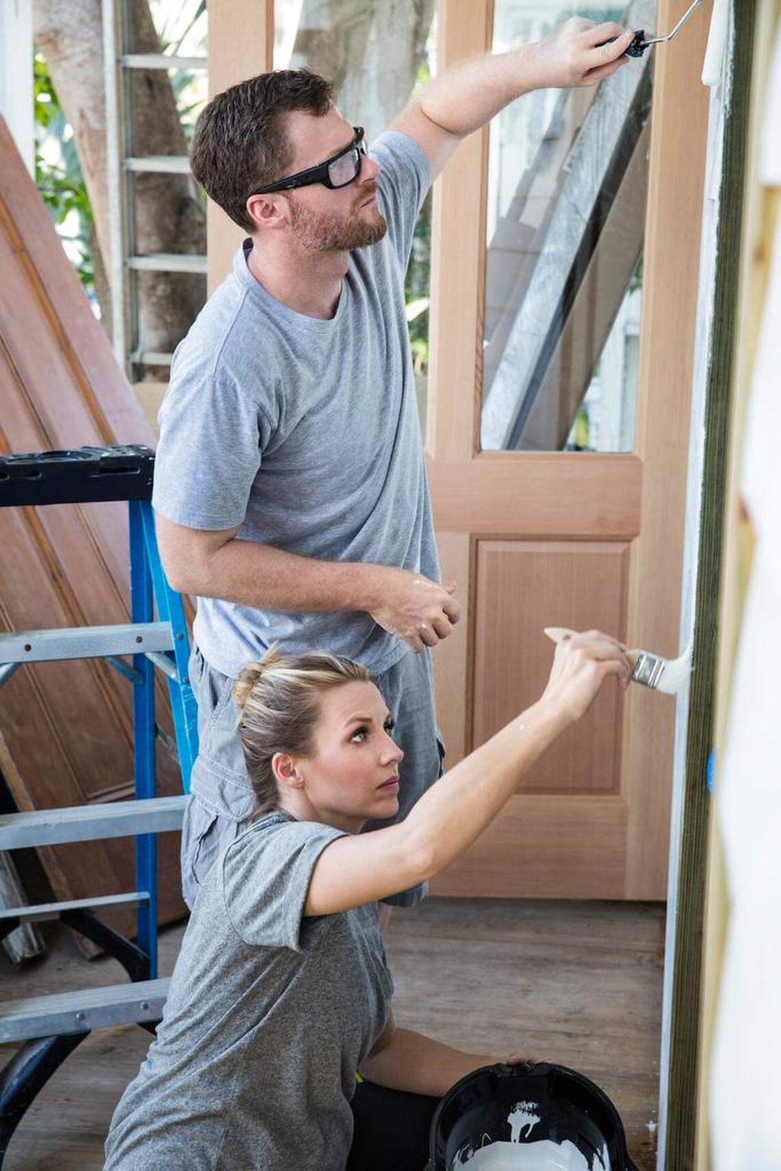 NASCAR star Dale Earnhardt Jr. and his wife Amy paint the exterior of the house.