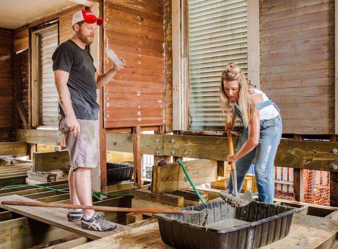 Interior designer Amy Earnhardt mixes up cement while her husband Dale takes a much-needed water break in Key West.