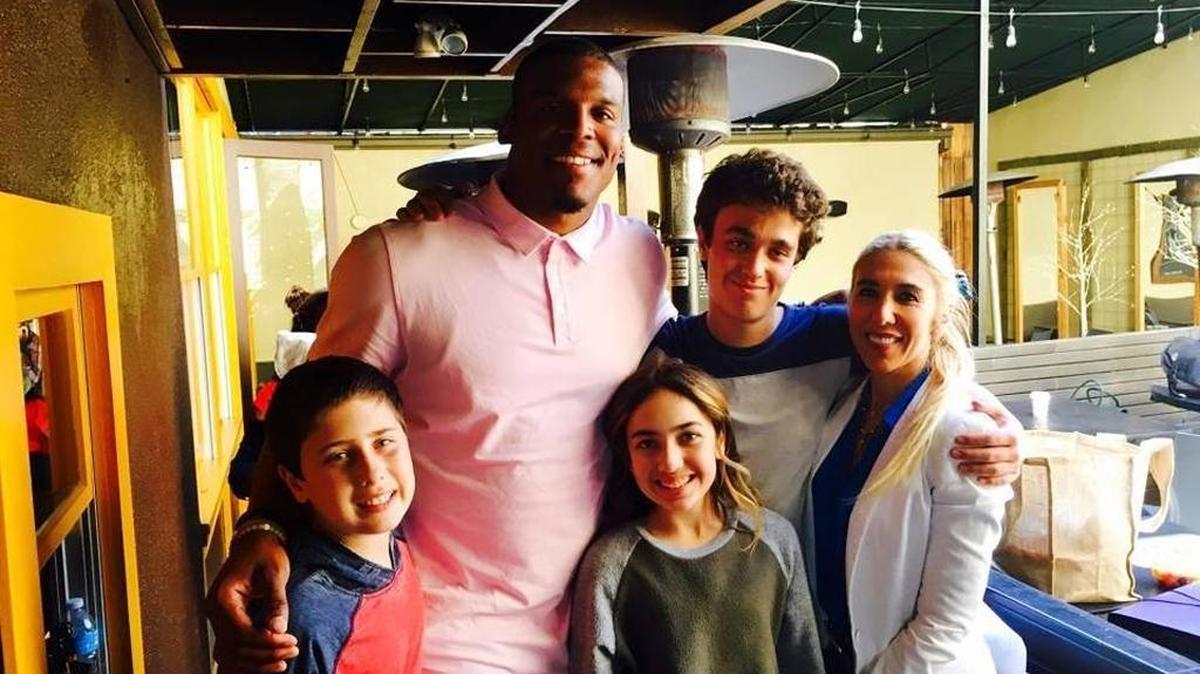 Cam Newton poses with Goldie Schneider (center), her siblings Leo and Jonathan, and their mother Marnie, during filming of Newton’s Nickelodeon series, “All In with Cam Newton.” Goldie spent time cooking with Newton as part of the children’s series.