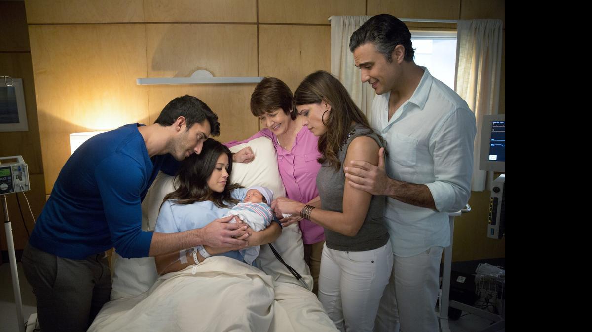 
(L-R): Justin Baldoni as Rafael, Gina Rodriguez as Jane, Ivonne Coll as Alba, Andrea Navedo as Xo and Jaime Camil as Rogelio on “Jane the Virgin.” 
