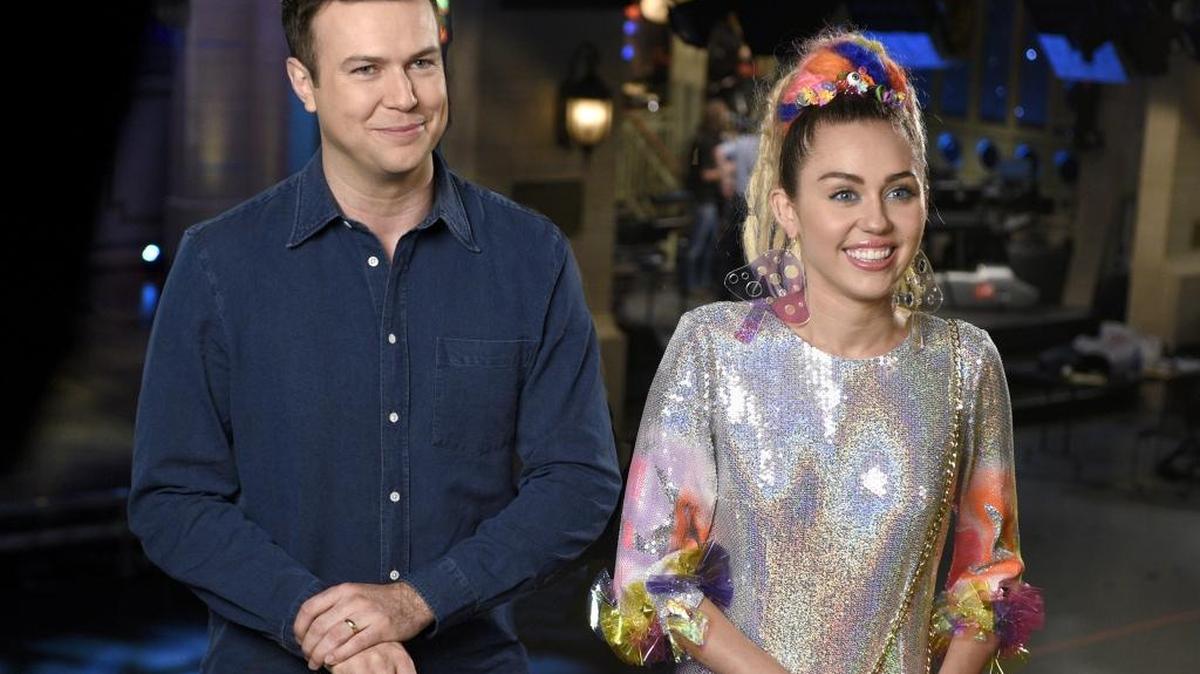 
Taran Killam (left) and host Miley Cyrus promote the new season premiere of “Saturday Night Live.”
