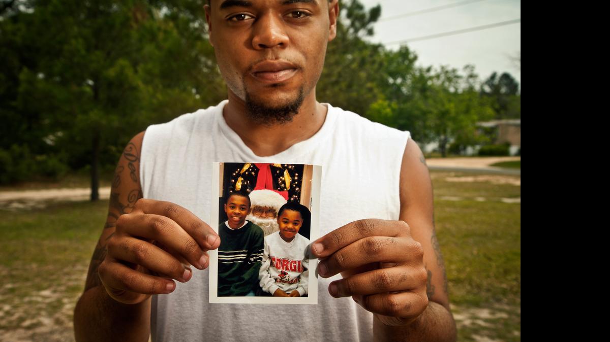 
Sha'von Patterson holds up a photo of him and his brother Justin Patterson, who was fatally shot in 2011. The story of his murder is told in the documentary “Southern Rites.”
