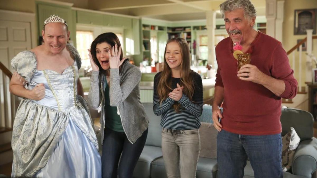 Tim (Dan Bakkedahl, left) thinks wearing a Cinderella dress during March Madness is good luck, so he refuses to take it off in hopes his alma mater will win. Also pictured (L-R): Betsy Brandt as Heather, Holly Barrett as Samantha and James Brolin as John.