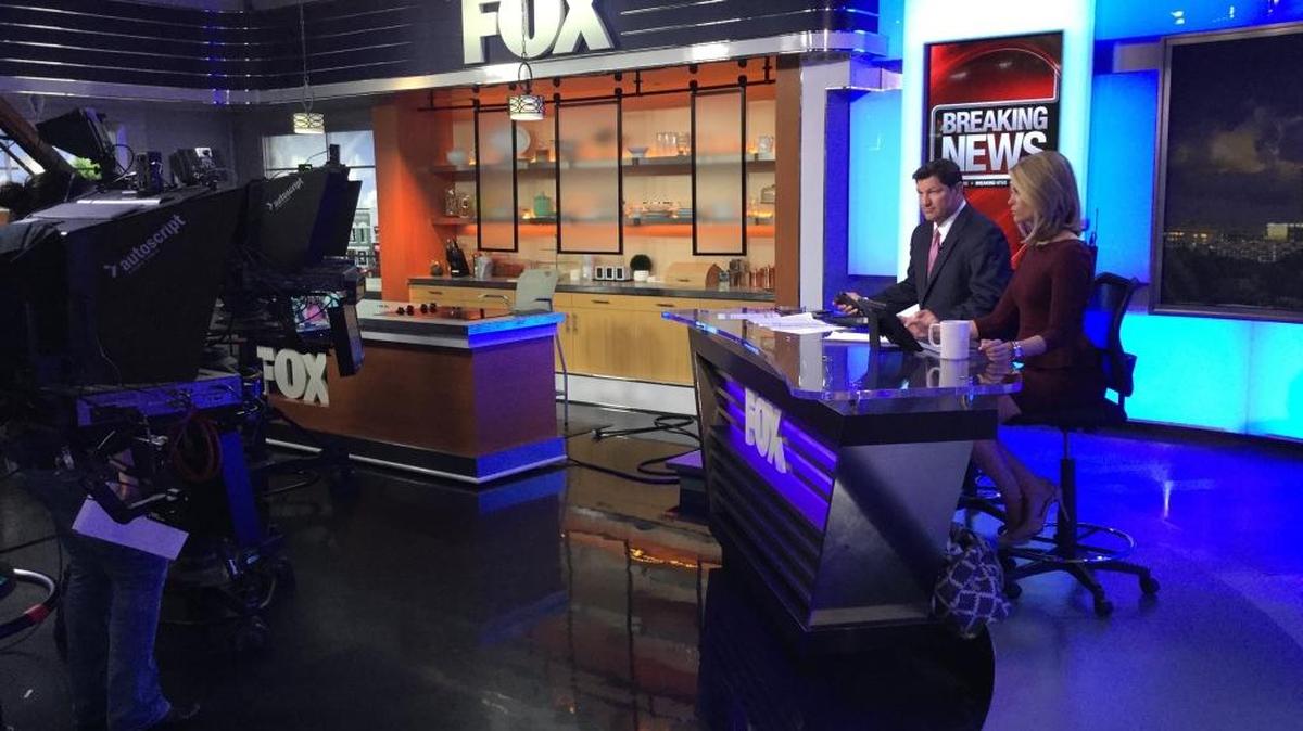 Brien Blakely and Kayla Ayres on the news set at WJZY (Channel 46). Fox46 redesigned its news set last year for a more authoritative presentation. “We wanted a more hard-news look,” said Council Bradshaw, who had a major hand in the redesign as vice president of creative services at the Fox-owned station.