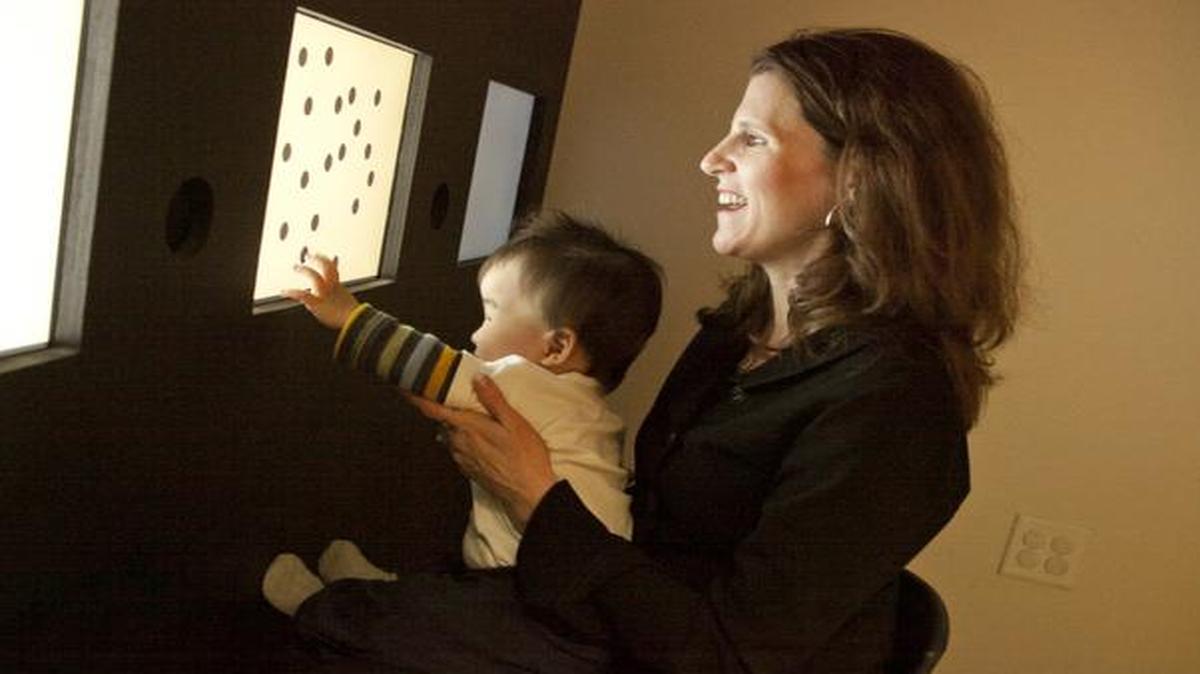 
Elizabeth Brannon in her lab with an infant demonstrating fundamental counting skills. 
