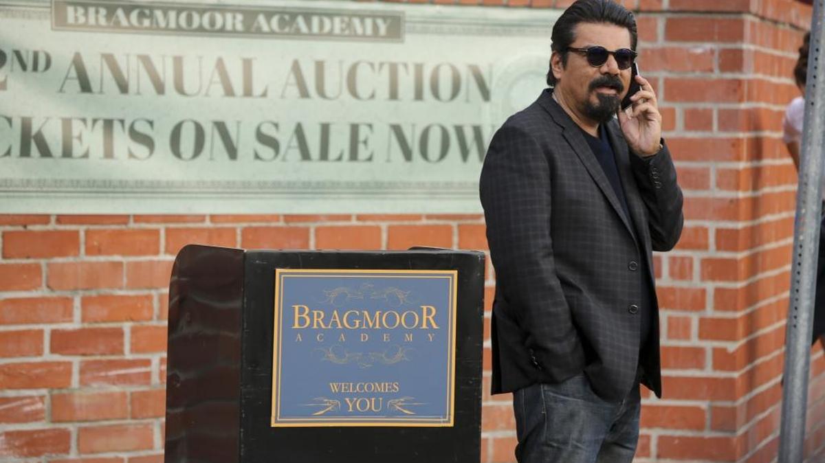 In the opening episode of “Lopez,” George waits outside Bragmoor Academy before being auctioned off.