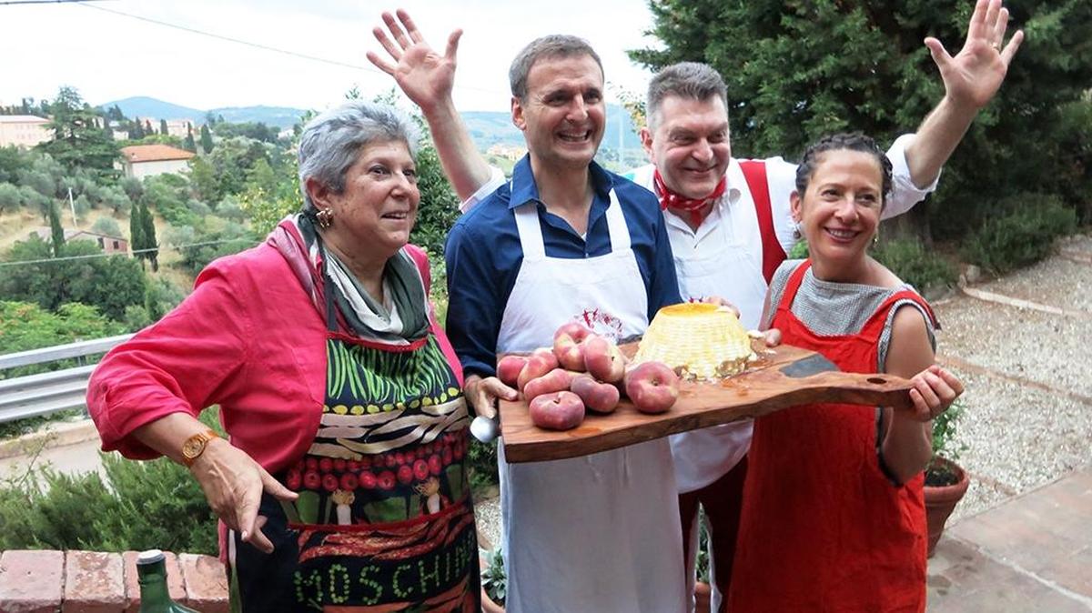 
Host Phil Rosenthal (holding the tray) visits Umbria, Italy. Here with chef and author Nancy Silverton (far right) and the world-famous Italian butcher Dario Cecchini.
