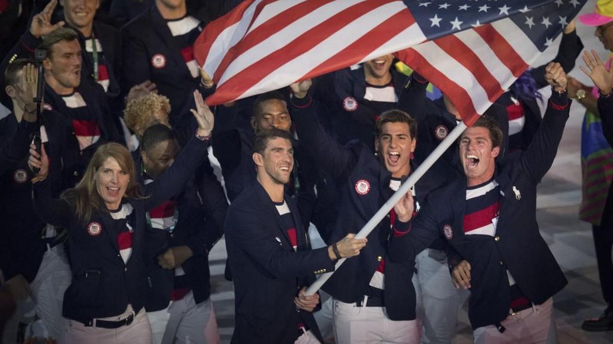 Swimmer Michael Phelps carries the flag to lead the U.S. team during the opening ceremonies of the Summer Olympic Games on Friday, Aug. 5, 2016, at Maracana Stadium in Rio de Janeiro, Brazil.