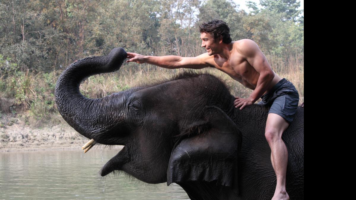 
Niall McCann, host of Nat Geo WILD’s “Biggest and Baddest,” on an elephant. 

