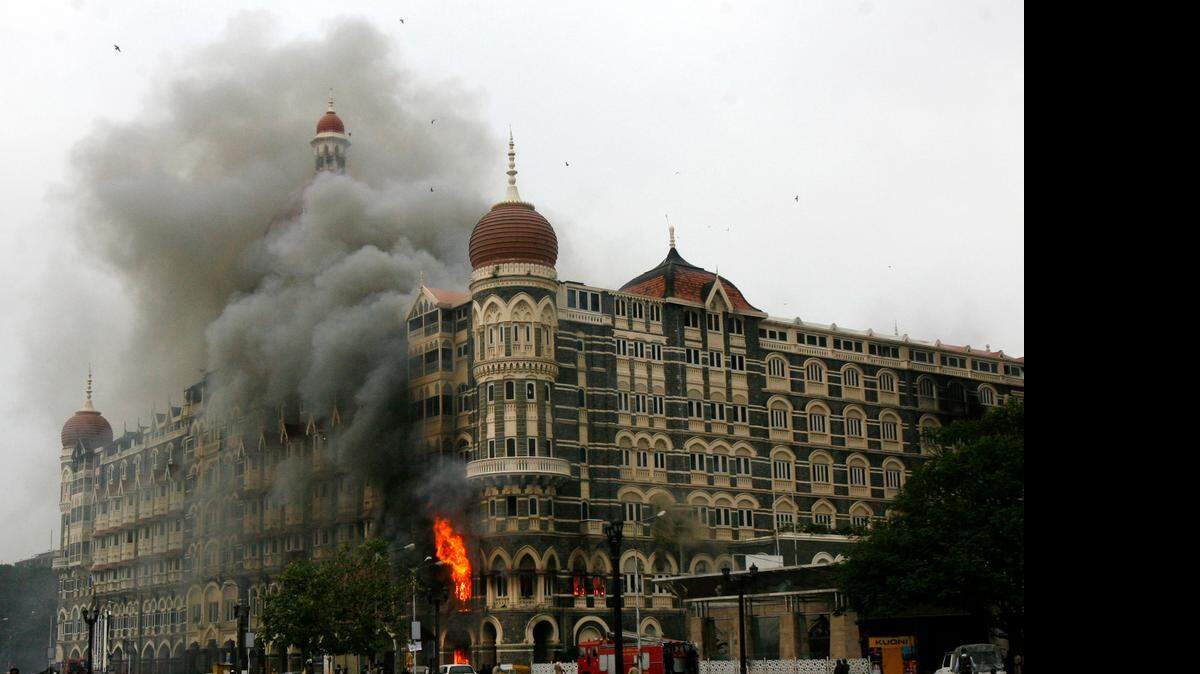 
The Taj Mahal hotel is seen engulfed in smoke during a gun battle in Mumbai November 29, 2008. American-born David Coleman Headley helped plan the attack. 


