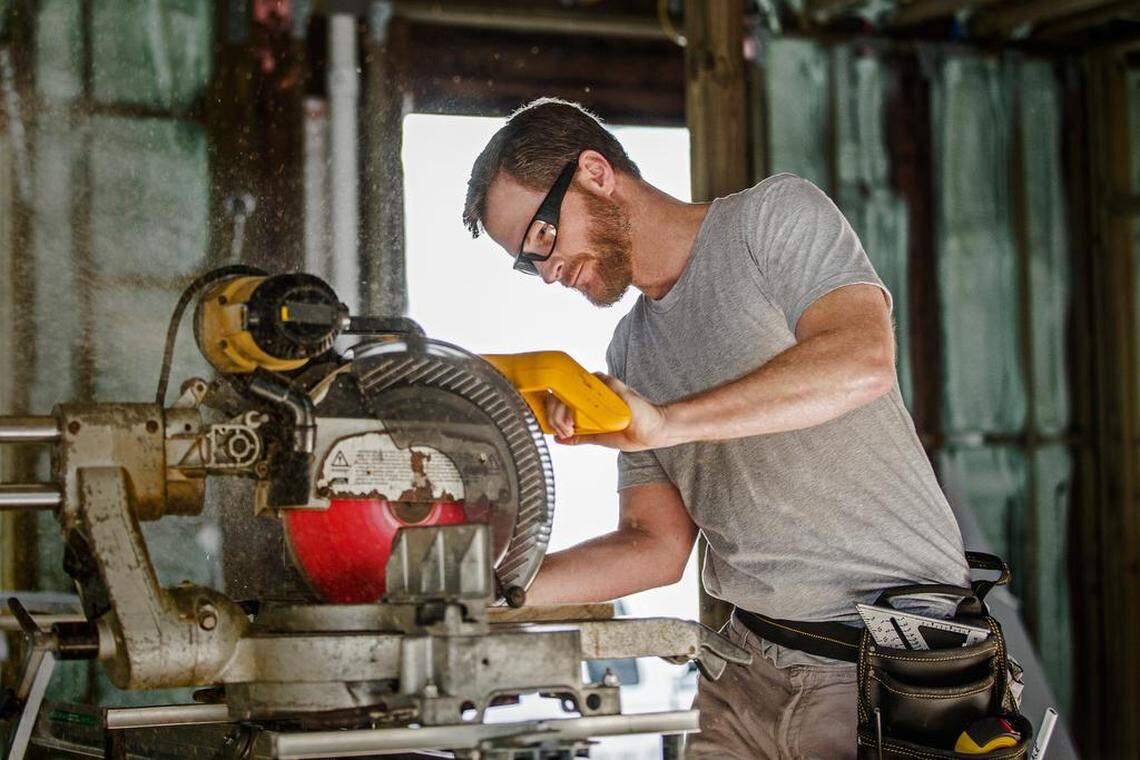 NASCAR star Dale Earnhardt Jr. cuts down the shiplap to be used in the dining room.