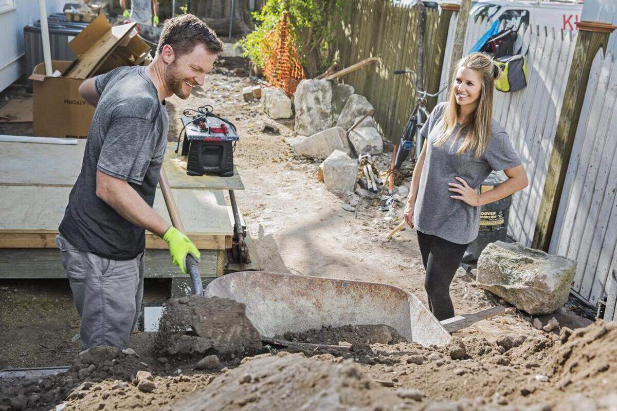 NASCAR star Dale Earnhardt Jr. shovels dirt as six-month pregnant wife Amy watches, as seen on DIY's "Renovation Realities: Dale Jr. & Amy."