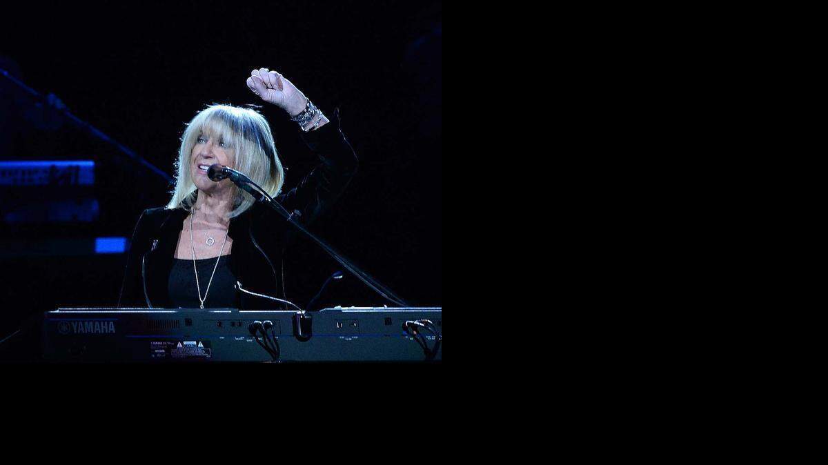 
 Christine McVie, waving to the crowd while she performs at Time Warner Cable Arena on Saturday, rejoined the band last year.

