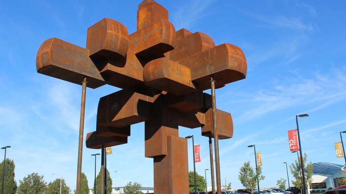 
A 40-foot tall, 40,000-pound sculputre is being installed in the the plaza of the Charlotte Douglas International Airport’s fixed base operator facility, which serves private aviation. The public artwork, titled “Old Growth,” is by Asheville artist Hoss Haley, and is designed to evoke the presence of a tree. The cost was $265,000 according to the Arts and Science Council, which manages the public art programs for the City of Charlotte and Mecklenburg County.
