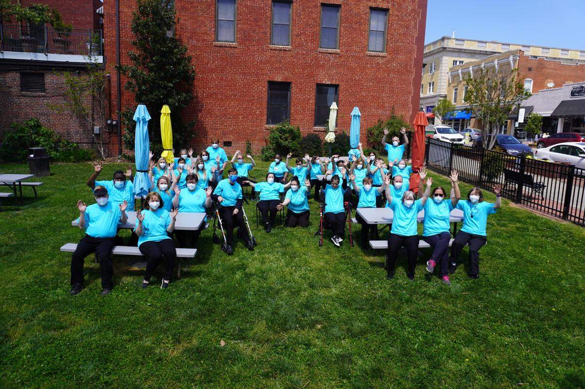 The Crew and Holy Angels staff outside of our businesses in Cherubs on the Green in downtown Belmont.