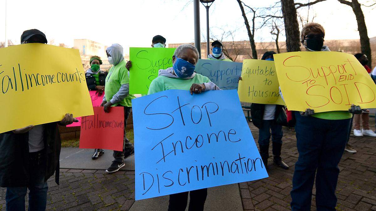 Advocates have rallied for a few years in Charlotte to amend local housing ordinances to provide protections against discrimination based on a rental applicant’s source of income, such as veterans benefits, disability checks and Section 8 housing vouchers. Photo from Feb. 22, 2021 rally outside the Charlotte-Mecklenburg Government Center in uptown.