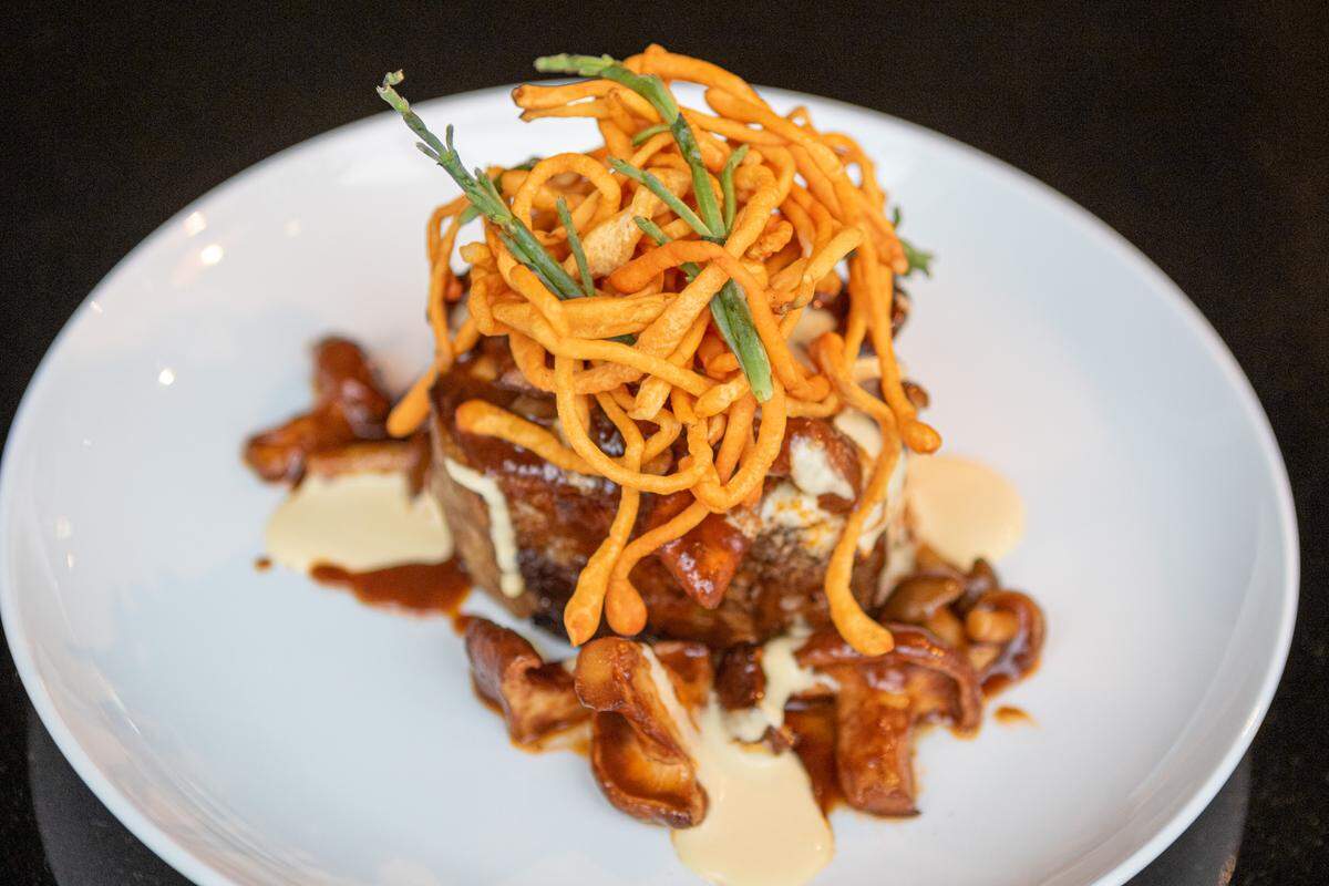 Lamb Neck at Kiki in Plaza Midwood. Braised lamb neck roulade, sautéed beech mushrooms, cordycep cream, cordyceps and sea beans.
