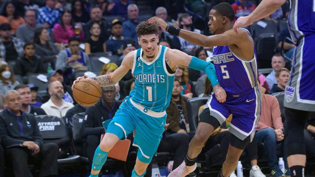 Charlotte Hornets guard LaMelo Ball (1) drives past Sacramento Kings guard De’Aaron Fox (5) during the first quarter of an NBA basketball game in Sacramento, Calif., Monday, Dec. 19, 2022. (AP Photo/Randall Benton)