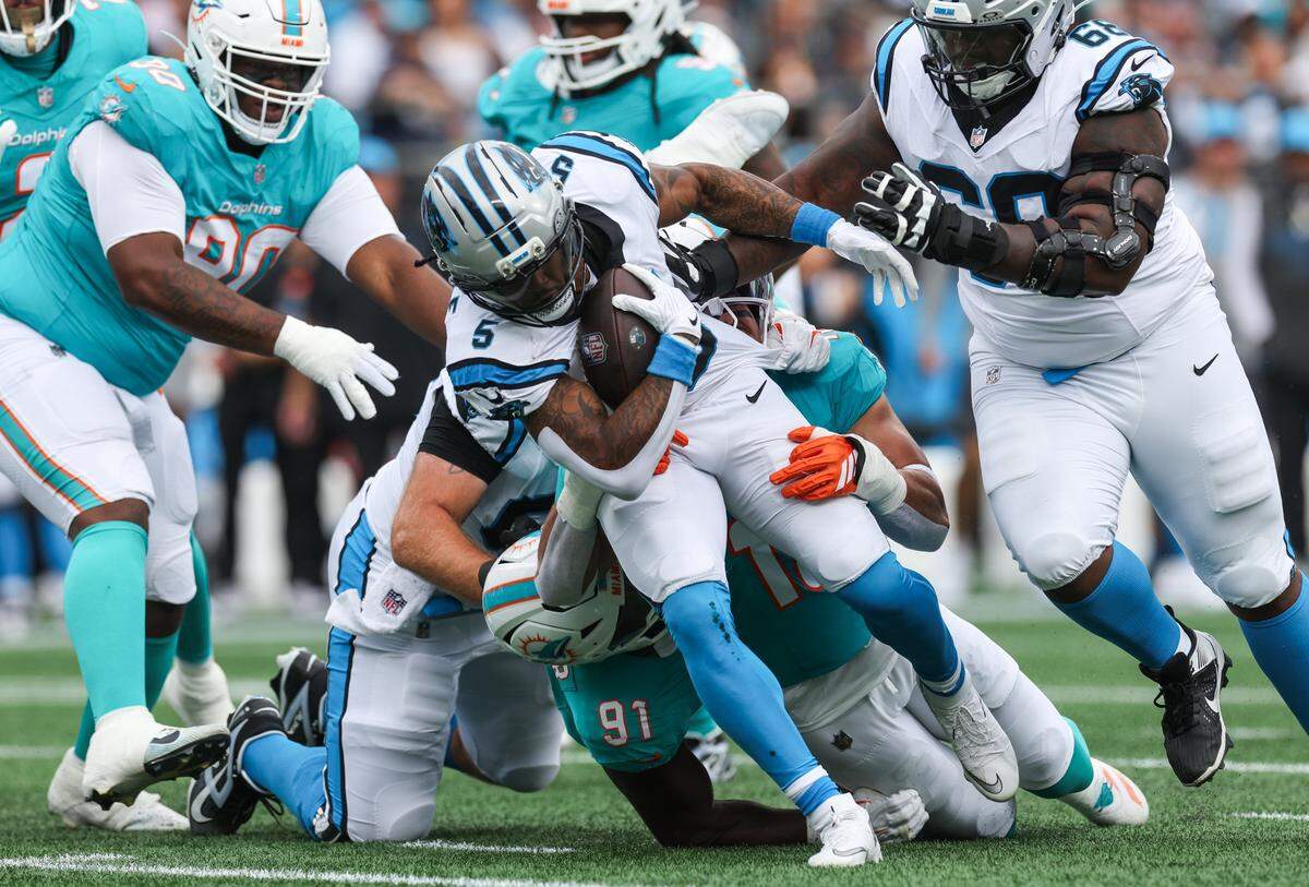 Panthers runningback Rico Dowdle pulls Dolphins defensive as he runs the ball during the game at Bank of America Stadium in Charlotte, NC on Sunday, October 5, 2025