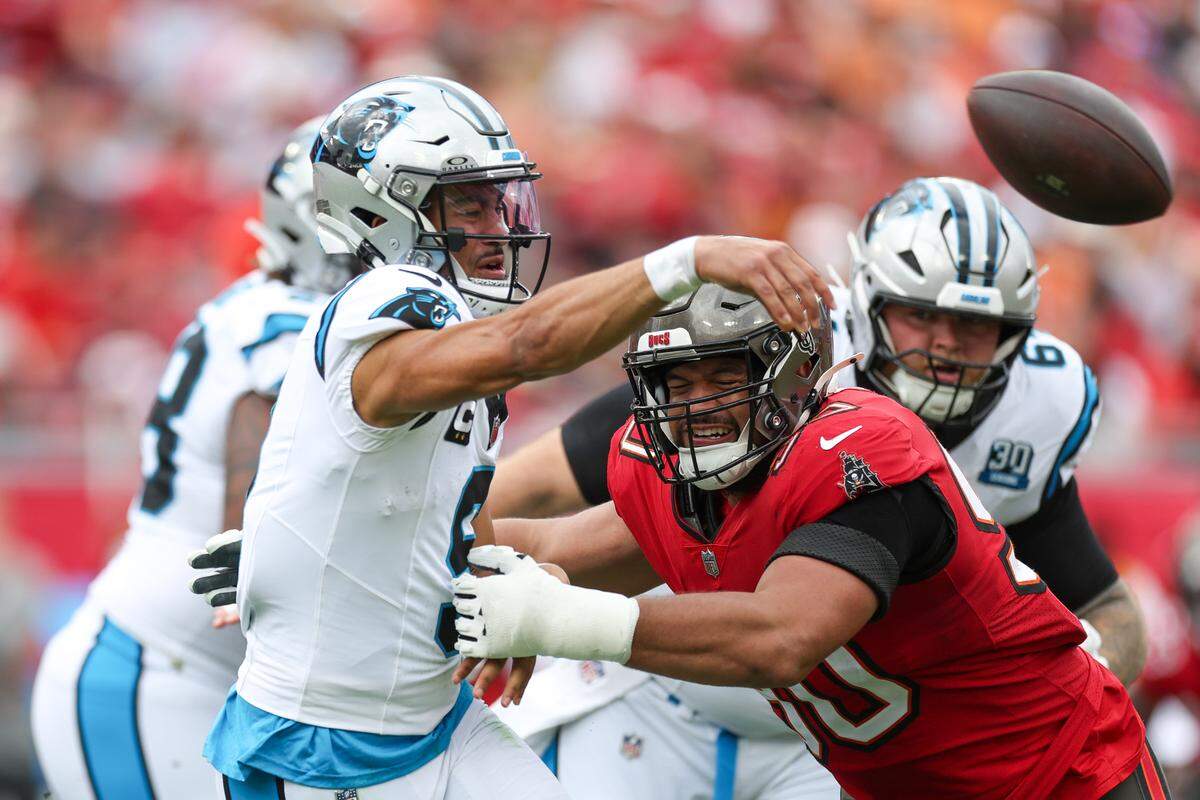 Carolina Panthers quarterback Bryce Young (9) is pressured by Tampa Bay Buccaneers defensive tackle Vita Vea (50) in the second quarter at Raymond James Stadium in Tampa, FL on Dec 29, 2024