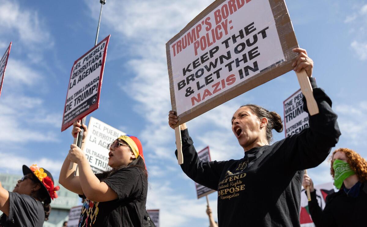 Protesters gather in First Ward Park before marching through uptown during a “Stop the Deportations” protest organized by Charlotte United for Palestine and the Party for Socialism and Liberation on Sunday.