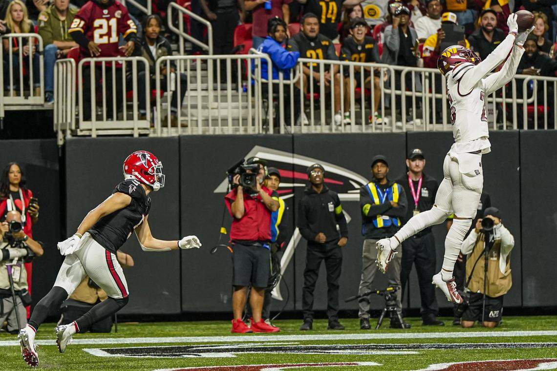 Oct 15, 2023; Atlanta, Georgia, USA; Washington Commanders cornerback Tariq Castro-Fields (26) intercepts a pass in the end zone in front of Atlanta Falcons wide receiver Drake London (5) during the second half at Mercedes-Benz Stadium. Mandatory Credit: Dale Zanine-USA TODAY Sports