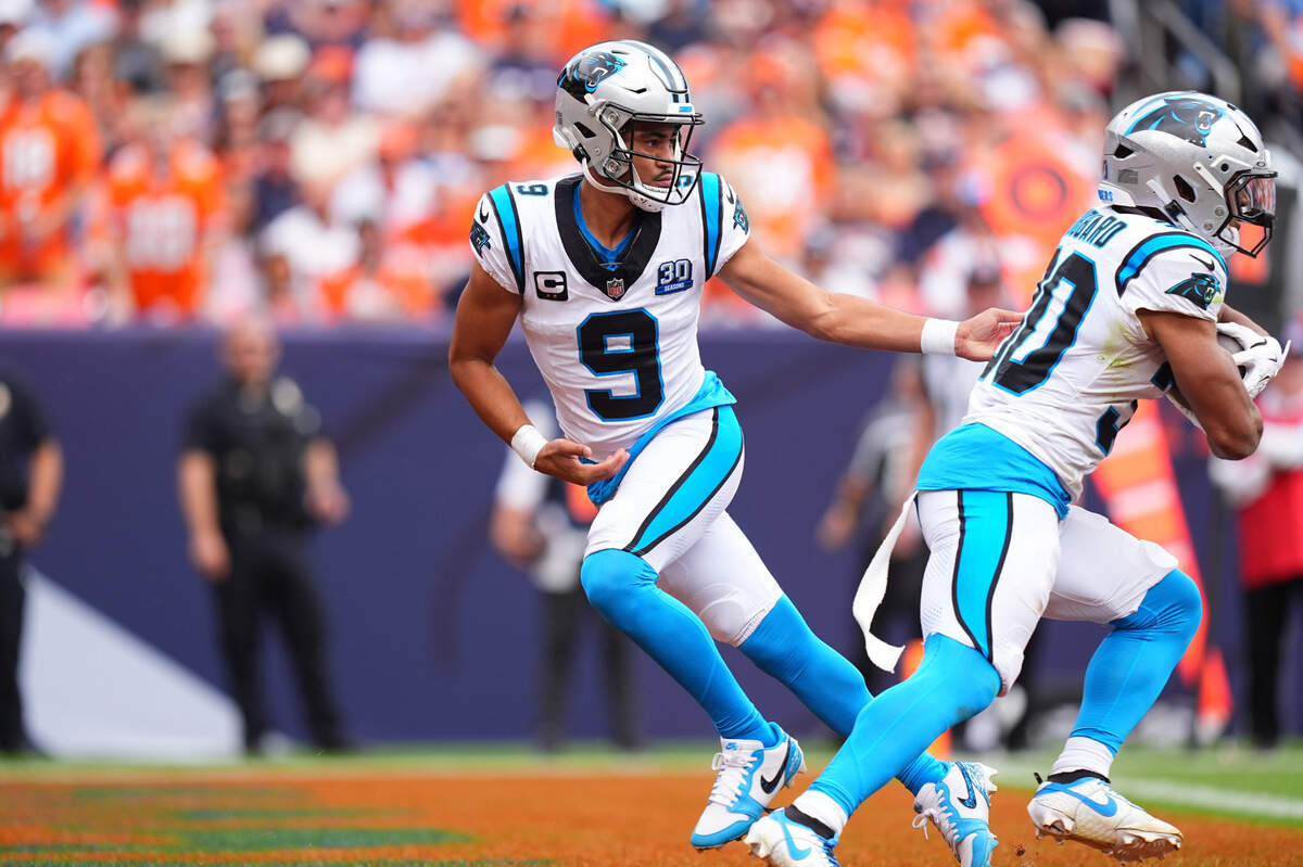 Carolina Panthers quarterback Bryce Young (9) hands the ball off to running back Chuba Hubbard (30) in Sunday’s first half against the Denver Broncos at Empower Field at Mile High. Ron Chenoy-Imagn Images