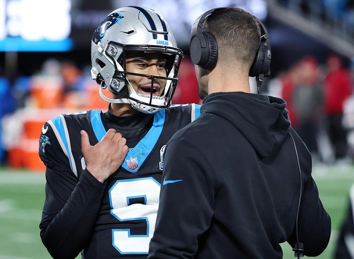 Carolina Panthers quarterback Bryce Young, left, speaks with head coach Dave Canales during a break in the action against the Tampa Bay Buccaneers at Bank of America Stadium in Charlotte, NC on Sunday, December 1, 2024.