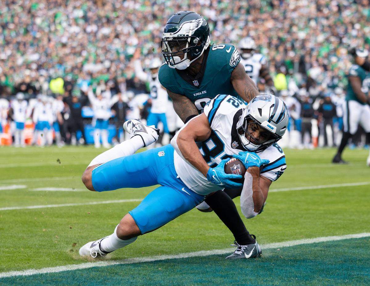 Dec 8, 2024; Philadelphia, Pennsylvania, USA;  Carolina Panthers tight end Tommy Tremble (82) scores a touchdown past Philadelphia Eagles safety C.J. Gardner-Johnson (8) during the second quarter at Lincoln Financial Field. Mandatory Credit: Bill Streicher-Imagn Images