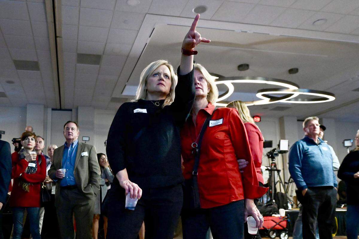 Lisa Thurlo, left, and Elizabeth Meaver, right, both of Davie County watch election results post on a video screen at Rep. Ted Budd’s viewing party in Winston-Salem, NC on Tuesday, November 8, 2022.