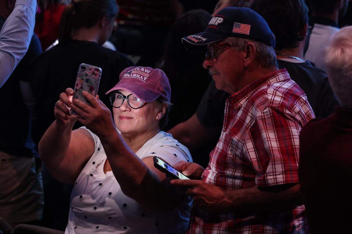 Supporters pull out their cell phones at the urging of Senator JD Vance, the GOP vice presidential candidate, as he encourages them to send a photo from the event to ten friends and tell them to vote on election day, during a rally at Freedom House Church in Charlotte, NC on Monday, September 23, 2024.