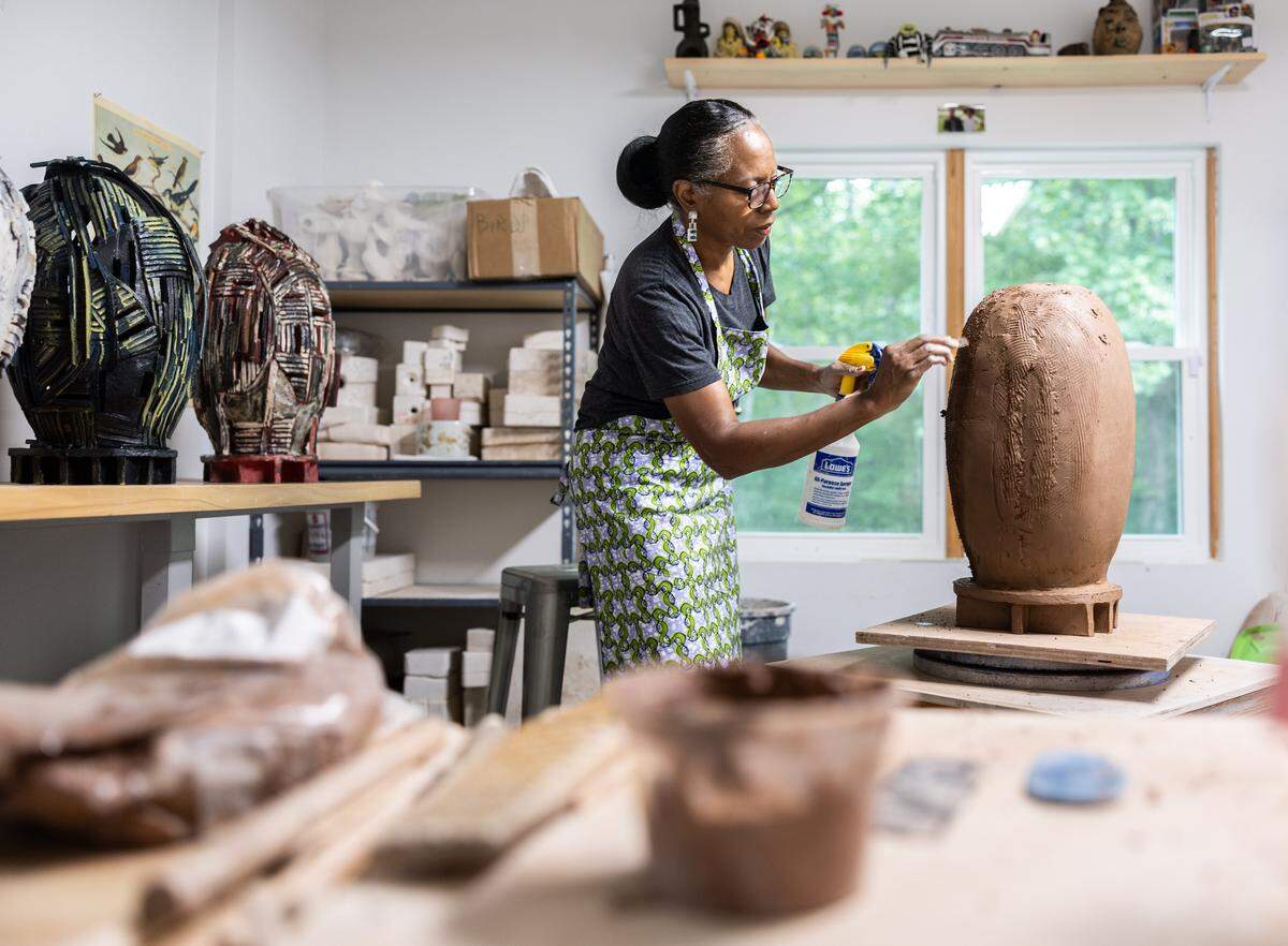 Professor Lydia Thompson, an art professor at the University of North Carolina at Charlotte, is currently working on an art piece in her studio in Charlotte on Thursday, August 7, 2025. Professor Thompson recently completed an international travel grant that facilitated her study of the art and culture in Ghana. In the fall, she will serve as an artist-in-residence at Starworks in Star, North Carolina, where she will develop a new body of work inspired by the adobe structures and traditional art forms she documented during her travels in Ghana.